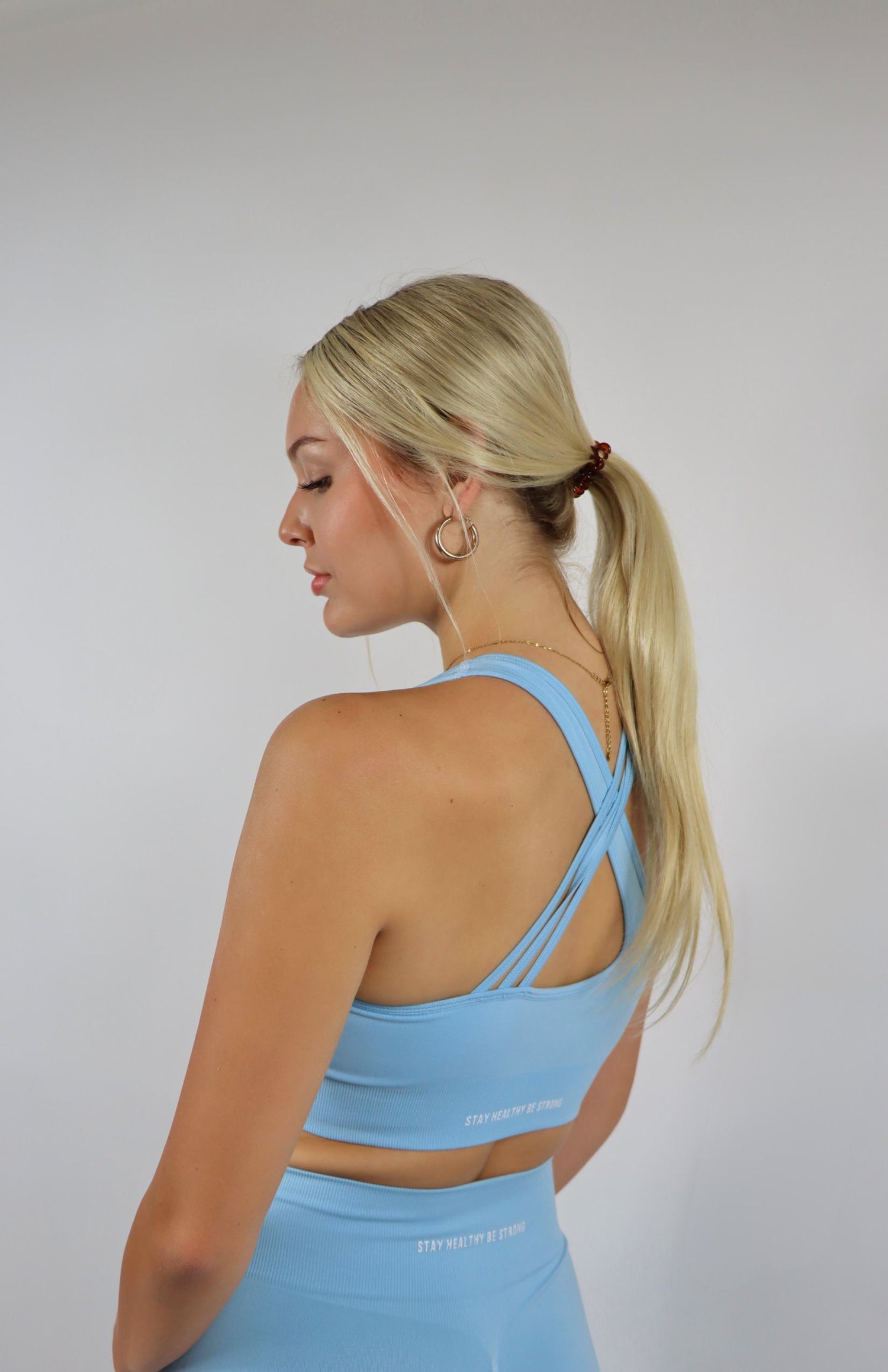 Baby blue high waisted scrunch leggings with baby blue cross back sports bra