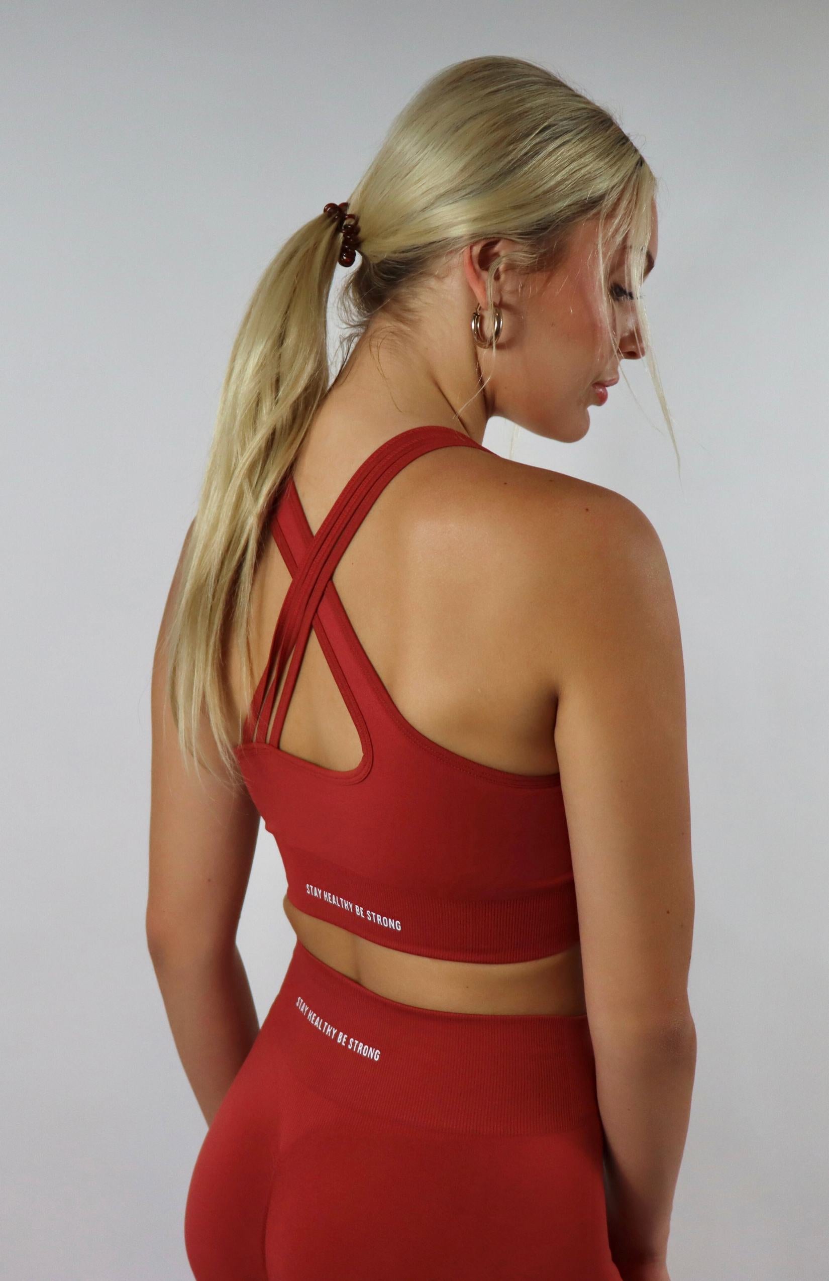 Red cross back sports bra with red  high waisted scrunch leggings with black cross back sports bra