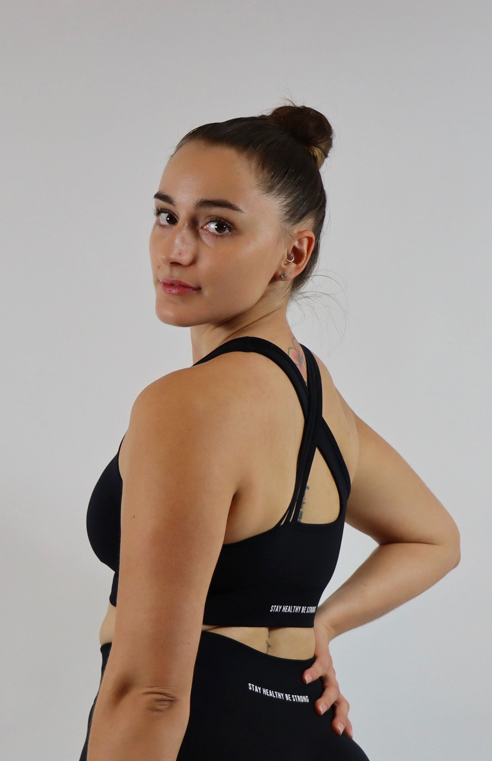 Black cross back sports bra with black high waisted scrunch leggings