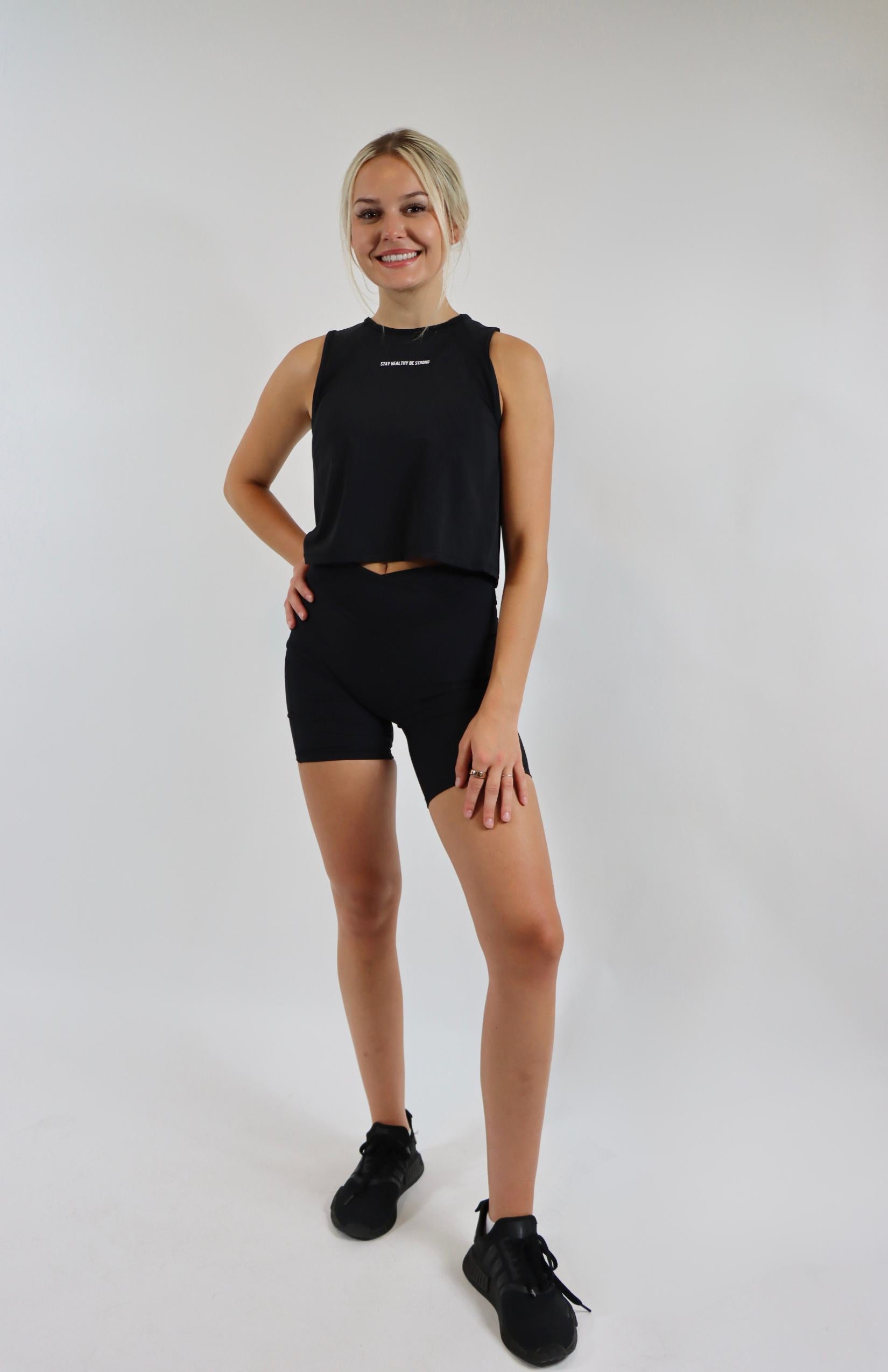 Black crossover cycling shorts with black cropped sleeveless tank top