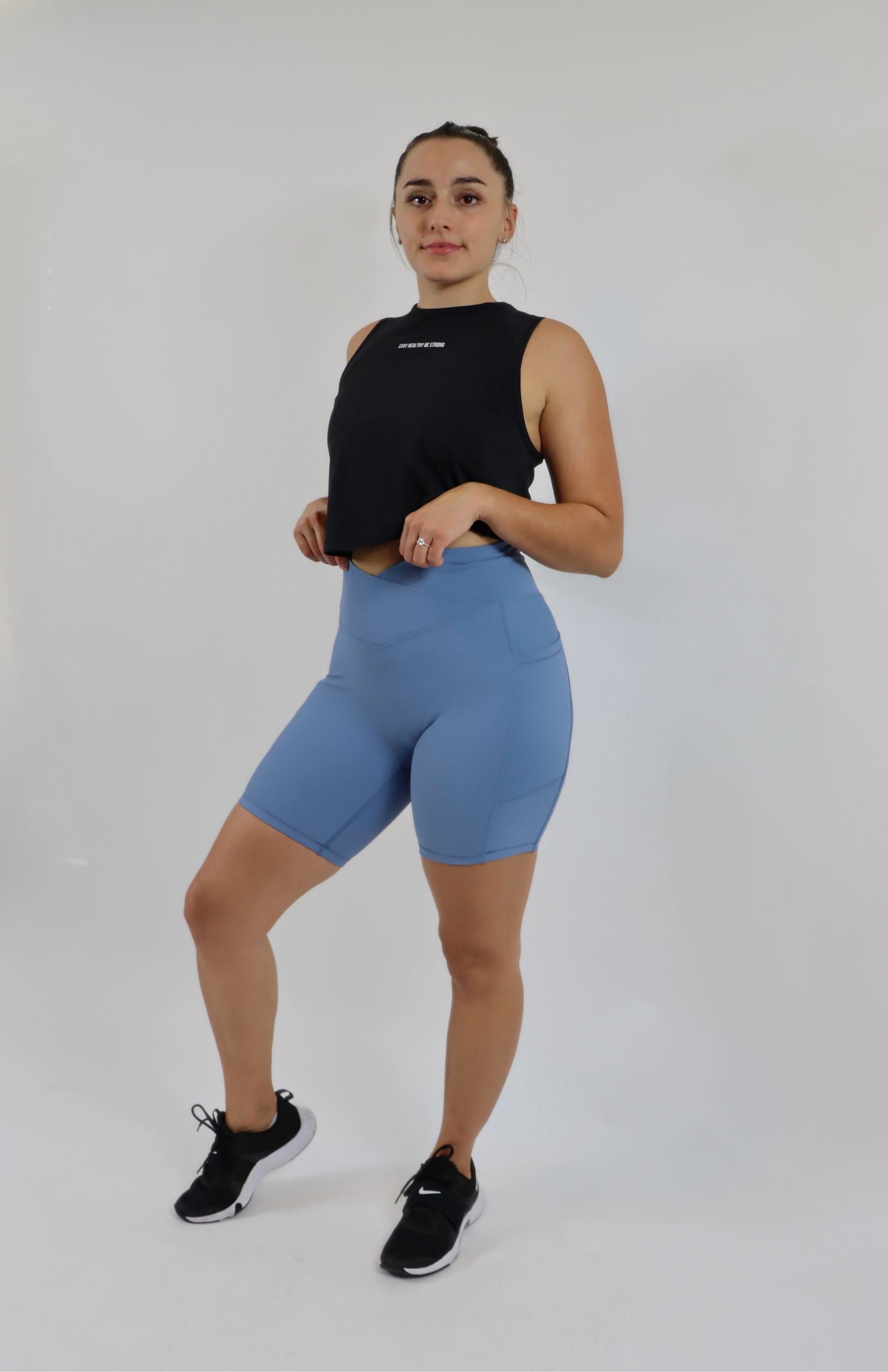 Blue crossover cycling shorts with black cropped sleeveless tank top