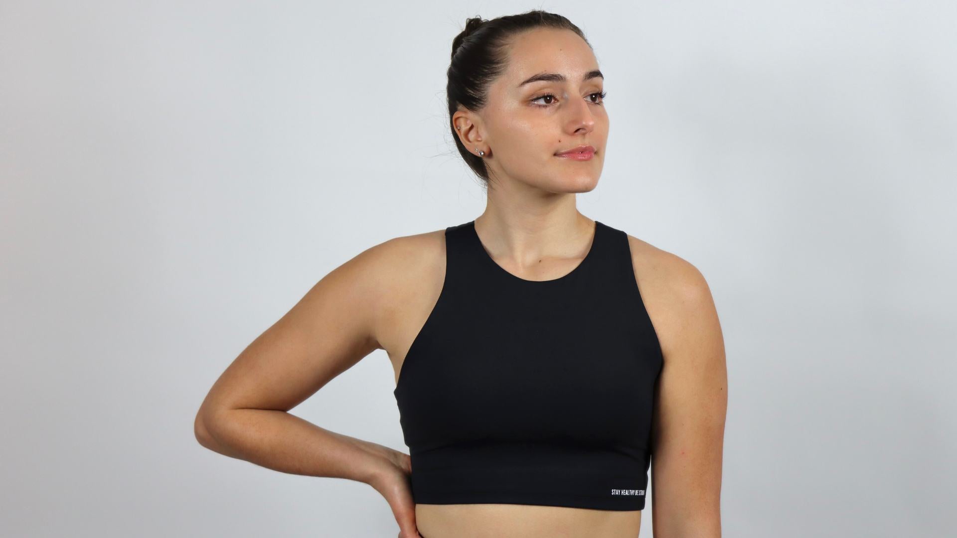 a women wearing a black high neck sports bra