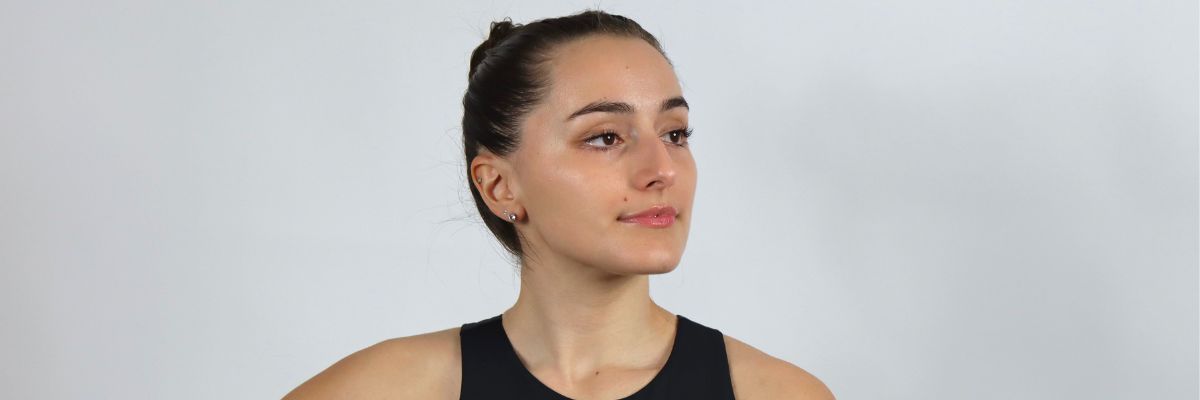 a head shot picture of a women wearing a black sports bra