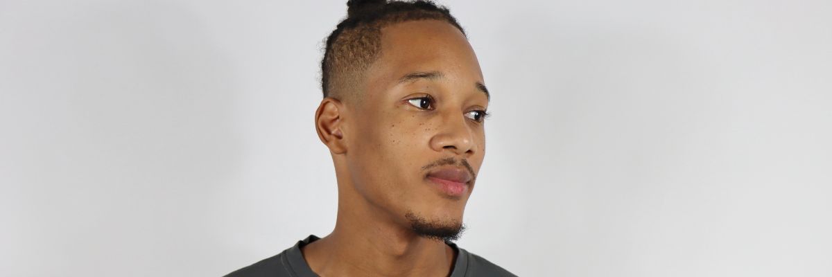 a head shot picture of a head shot of a men wearing a black t-shirt 