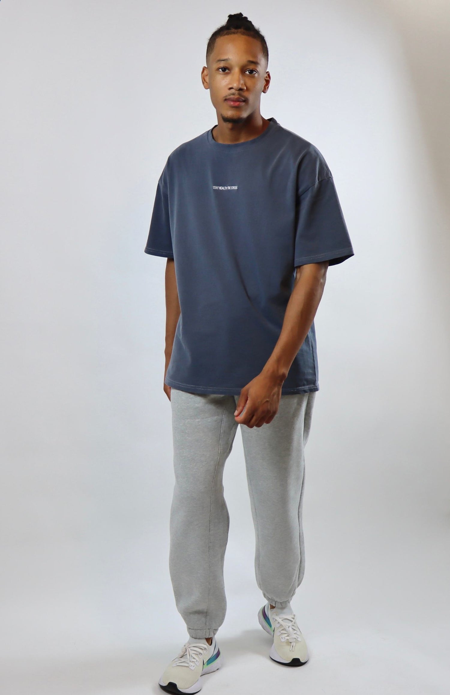 Faded blue oversized T-shirt and light gray oversized sweatpants