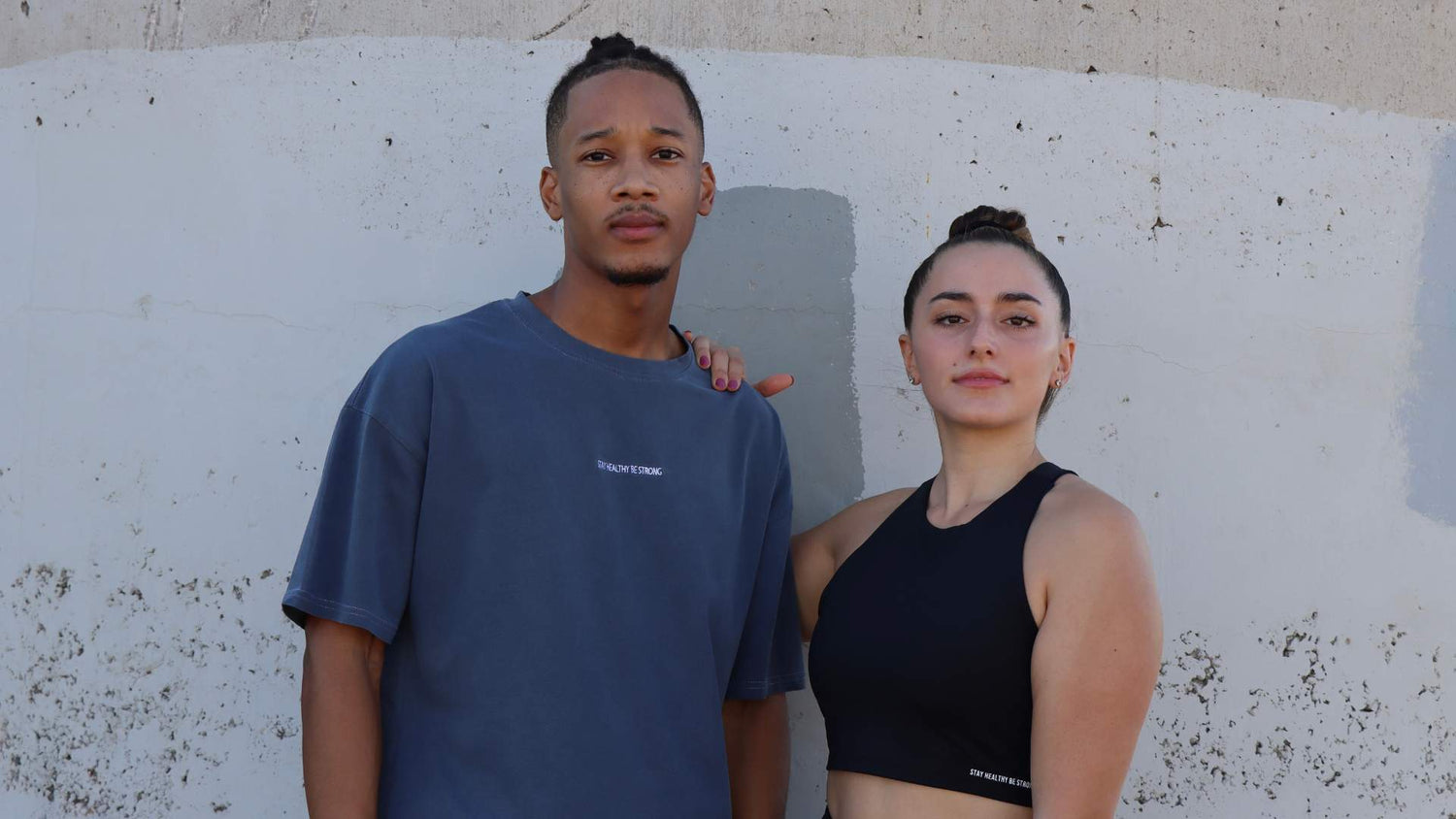 Black high-neck sports bra and faded blue oversized T-shirt