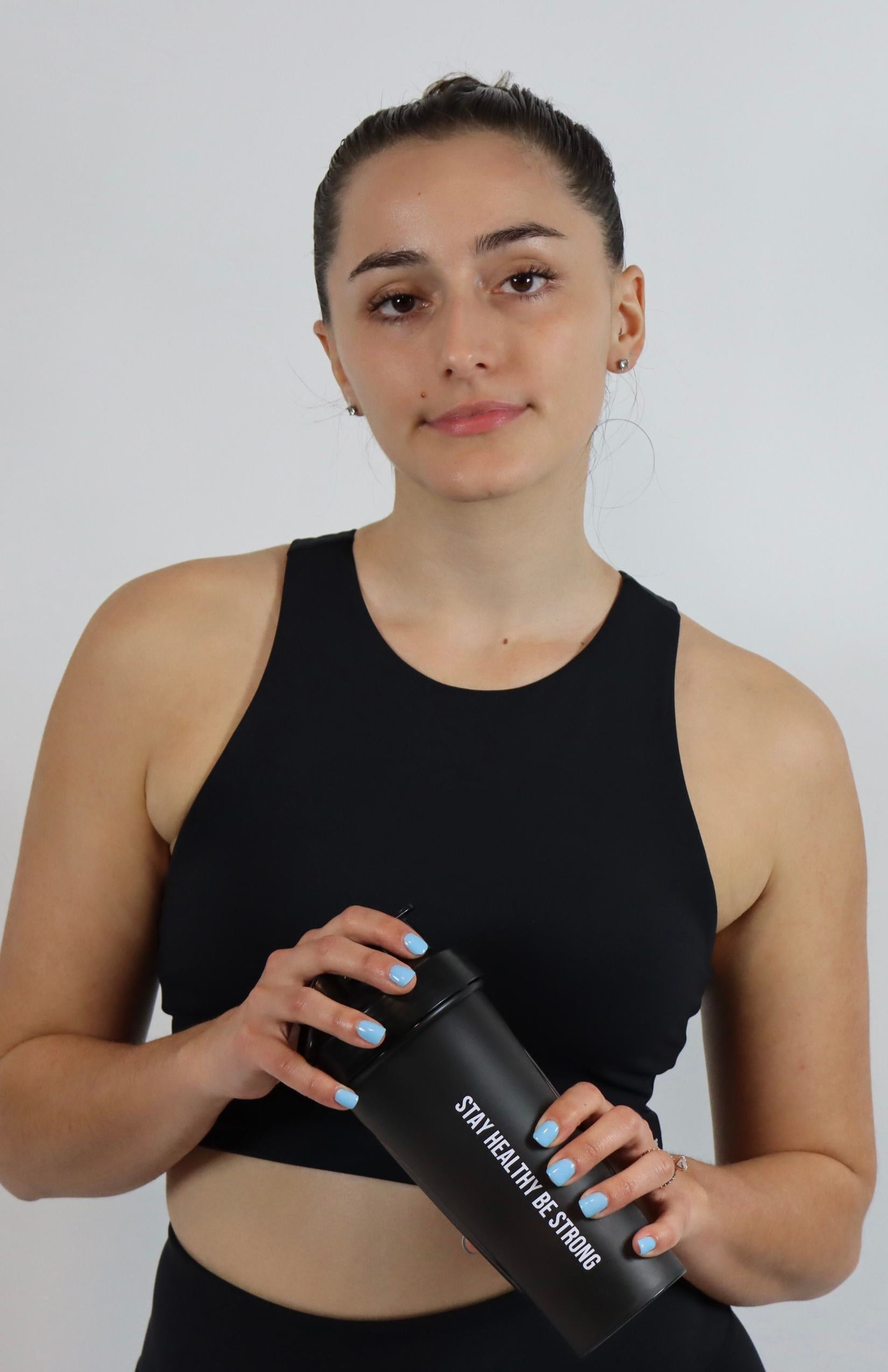 Black shaker bottle with black high-neck sports bra