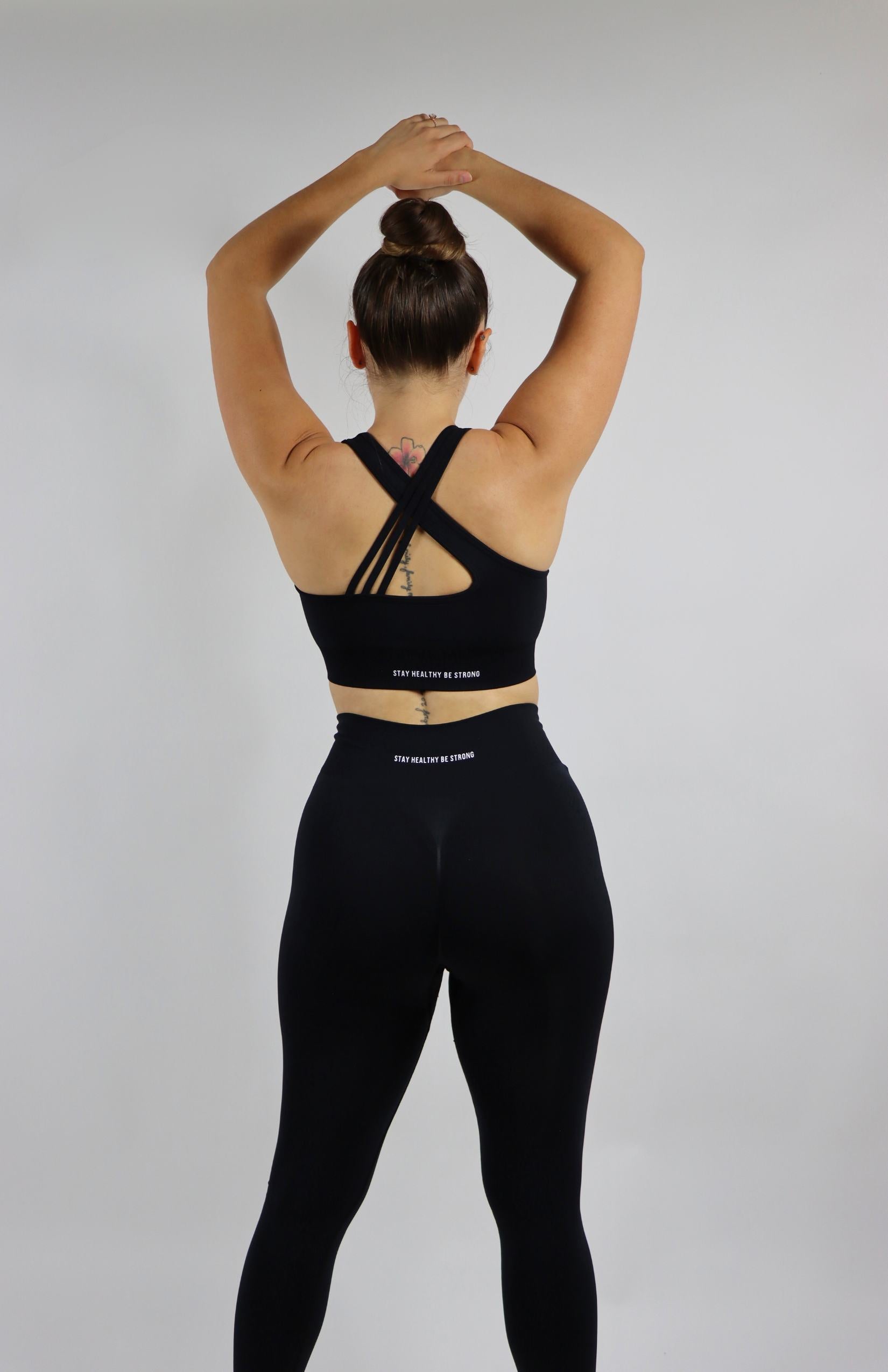 Black high waisted scrunch leggings with black cross back sports bra 