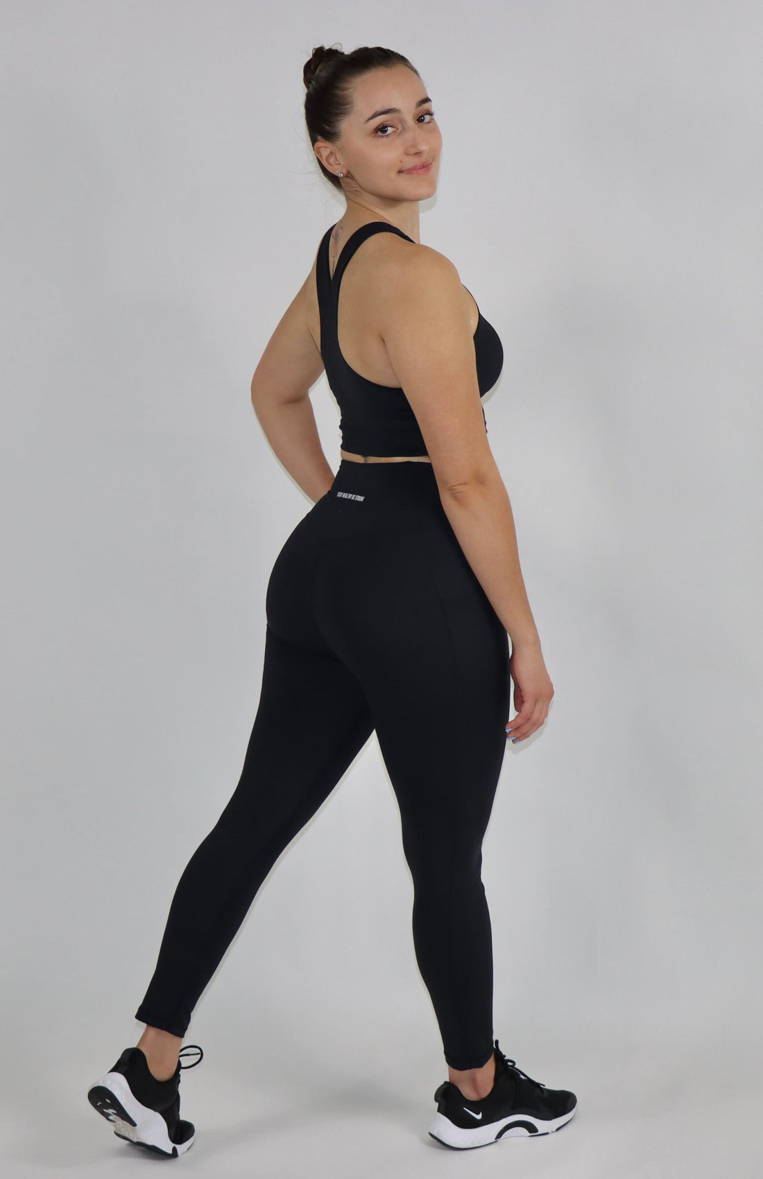 Black high waist pocket leggings with black high-neck sports bra