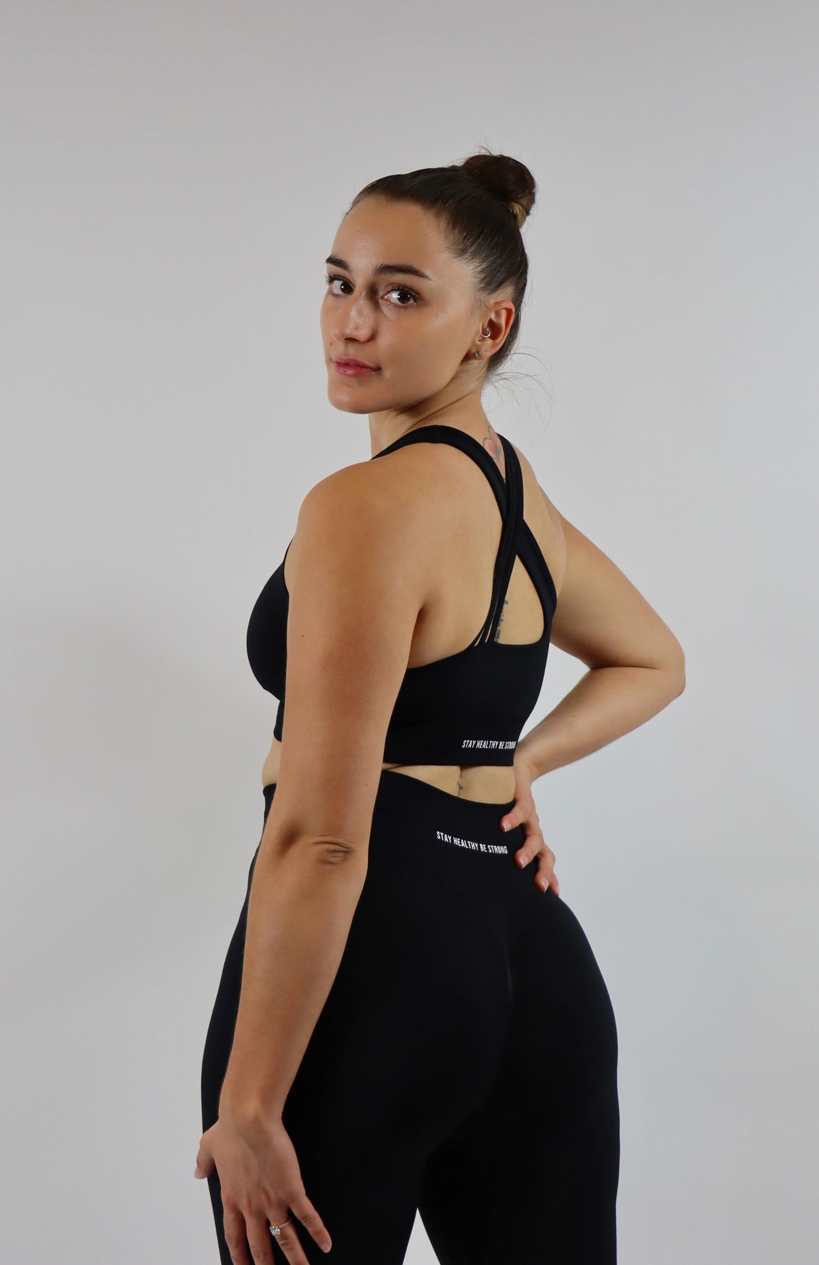 Black cross back sports bra with black high waisted scrunch leggings