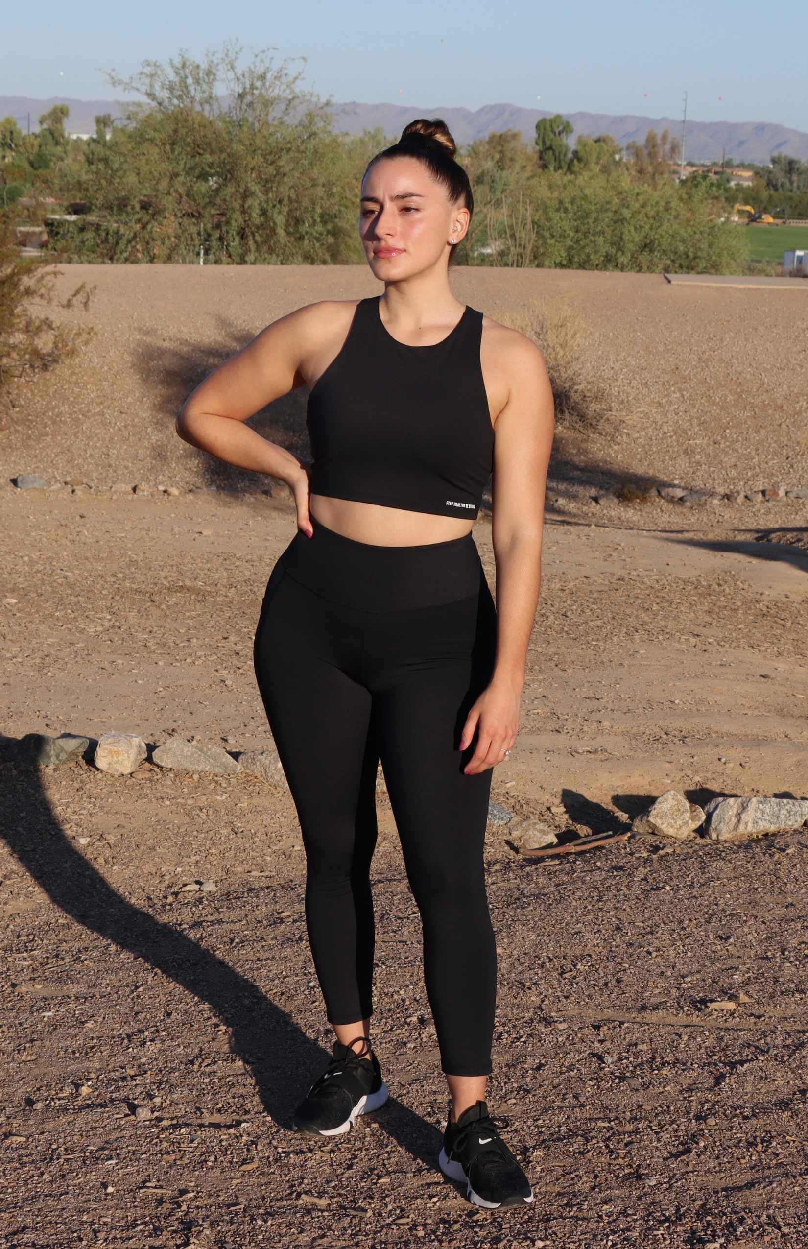 Black high-neck sports bra with black leggings