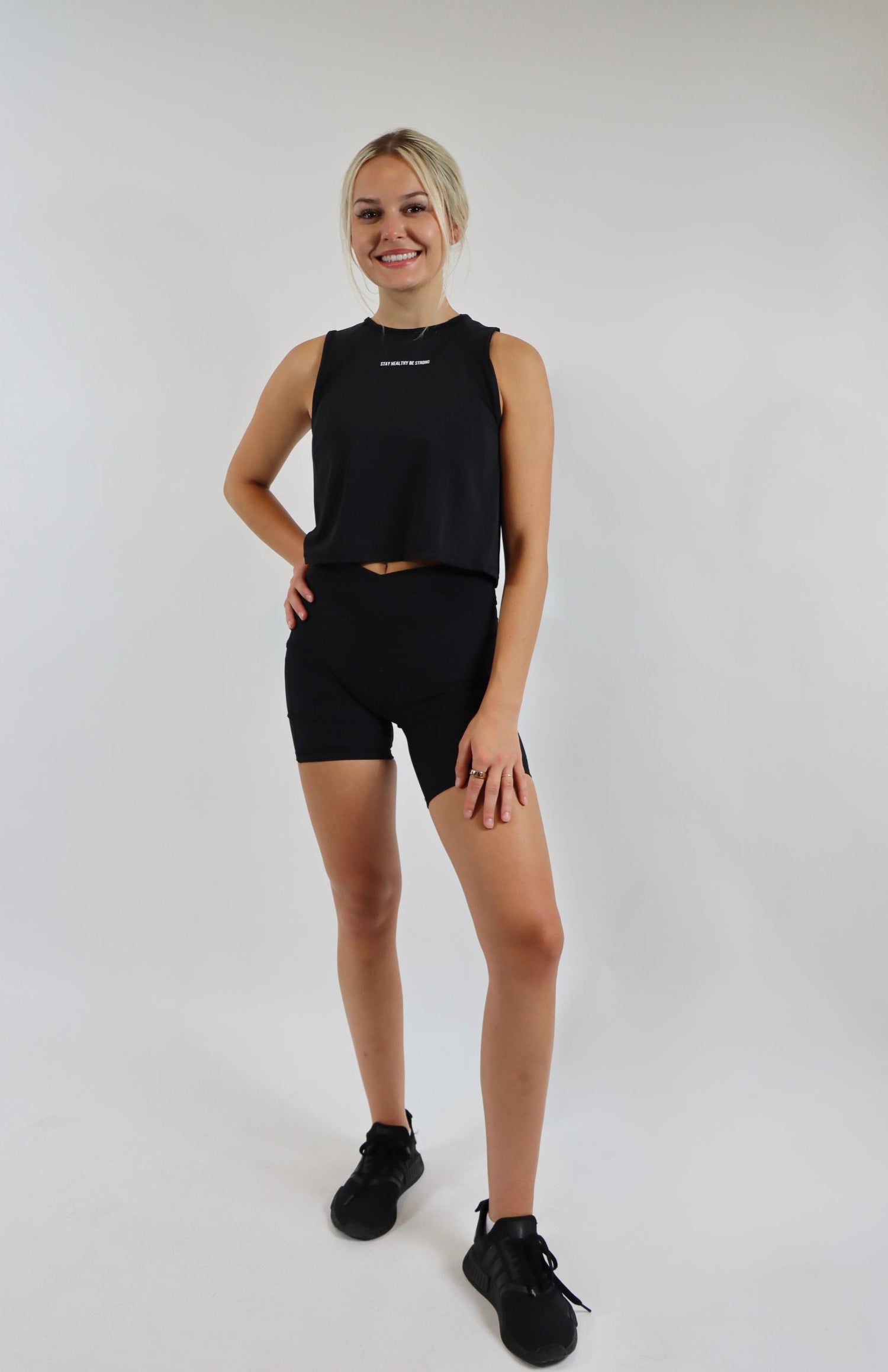 Black crossover cycling shorts with black cropped sleeveless tank top 